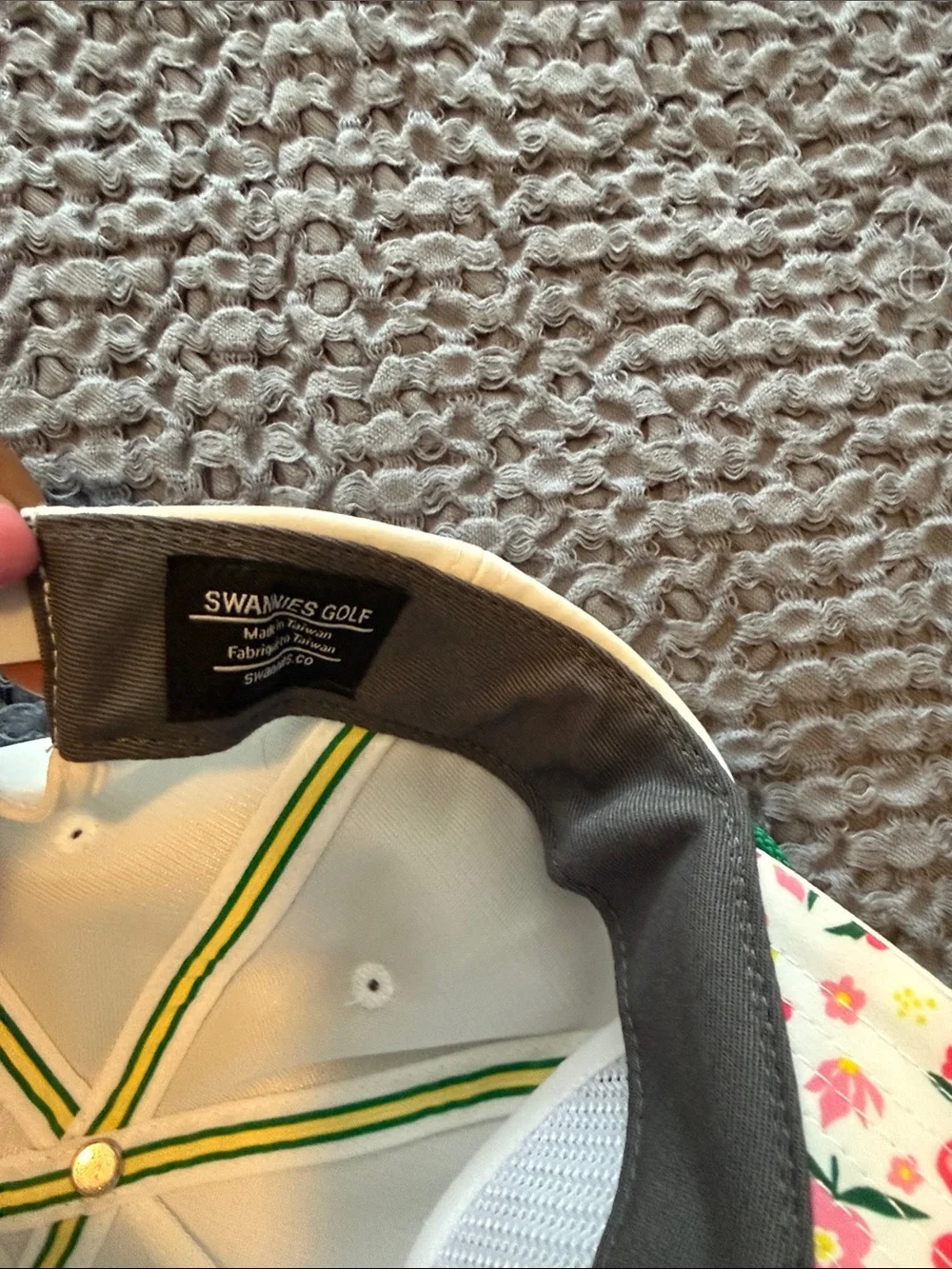 White woman's golf  Cap with Green Trim and Swan Logo.